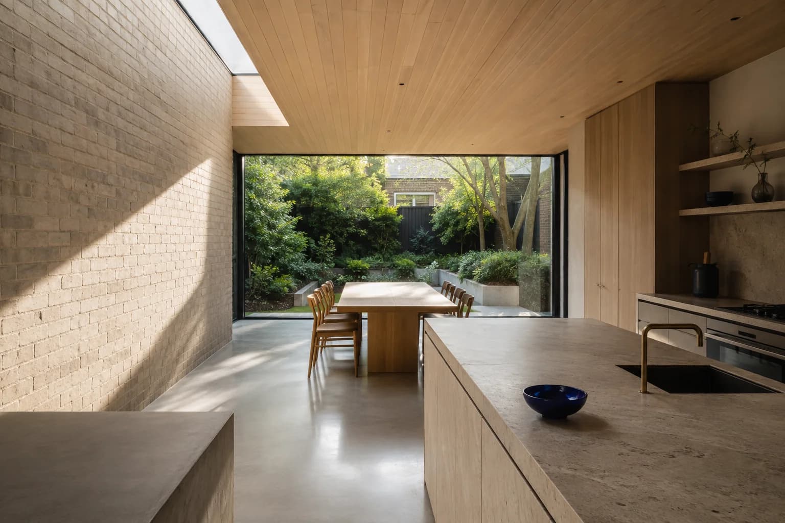 Illustrative interior concept with oak joinery, a skylight and garden views
