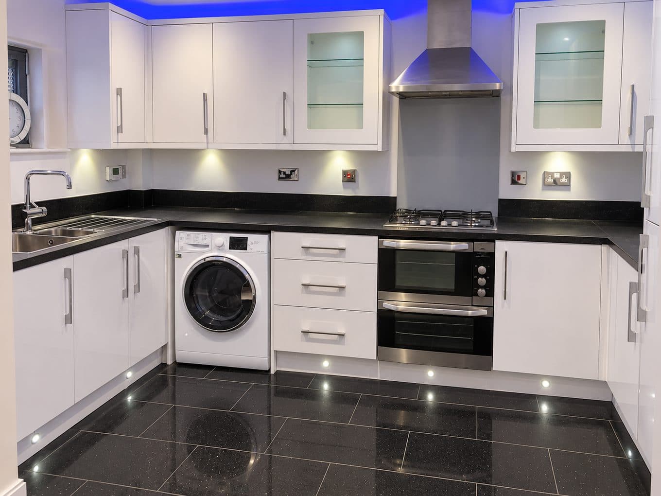 Luke Smith’s fitted kitchen with white gloss cupboards, black granite worktops and under-unit lighting